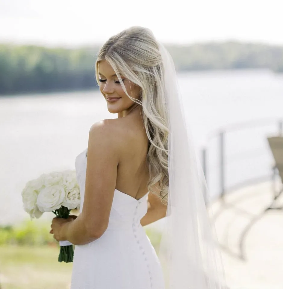 Real Glowtoure bride in a button-back gown and veil with a soft, camera-ready wedding-day glow