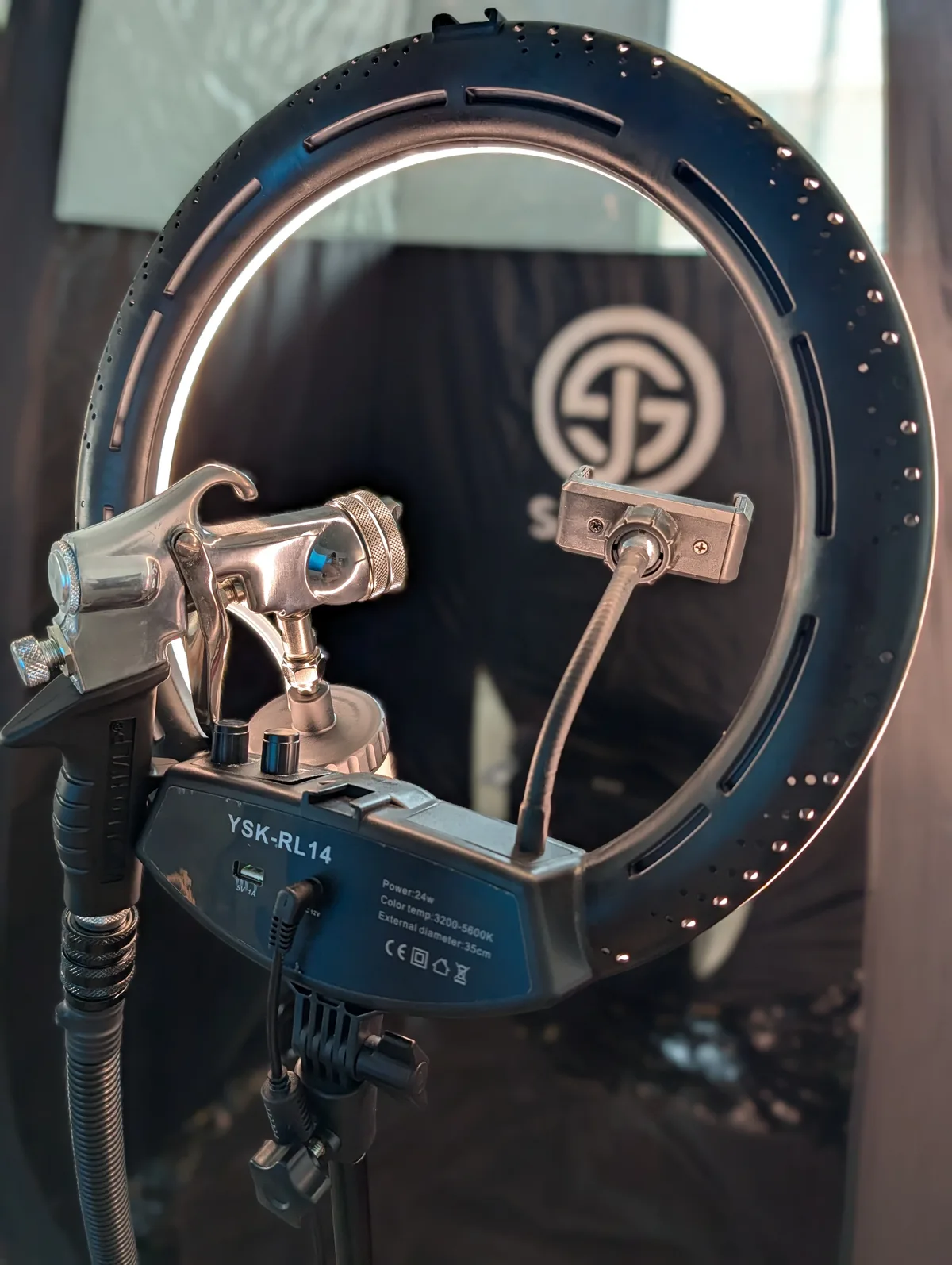 The Glowtoure professional mobile spray tan setup — ring light and airbrush against the branded backdrop, ready for a Sacramento appointment
