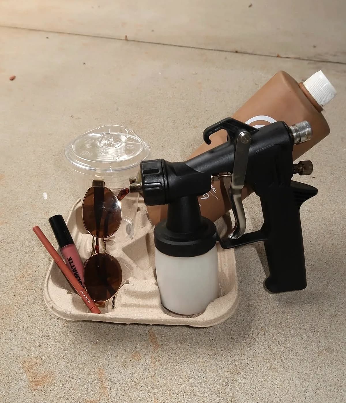 Glowtoure spray tan gun, custom solution, and finishing touches packed in a carrier, ready to travel to a mobile appointment